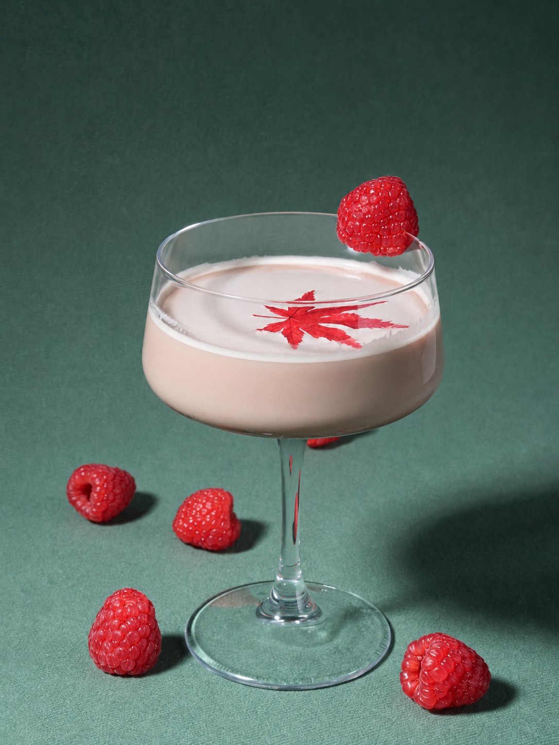 Raspberry oat milk coffee garnished with fresh raspberries