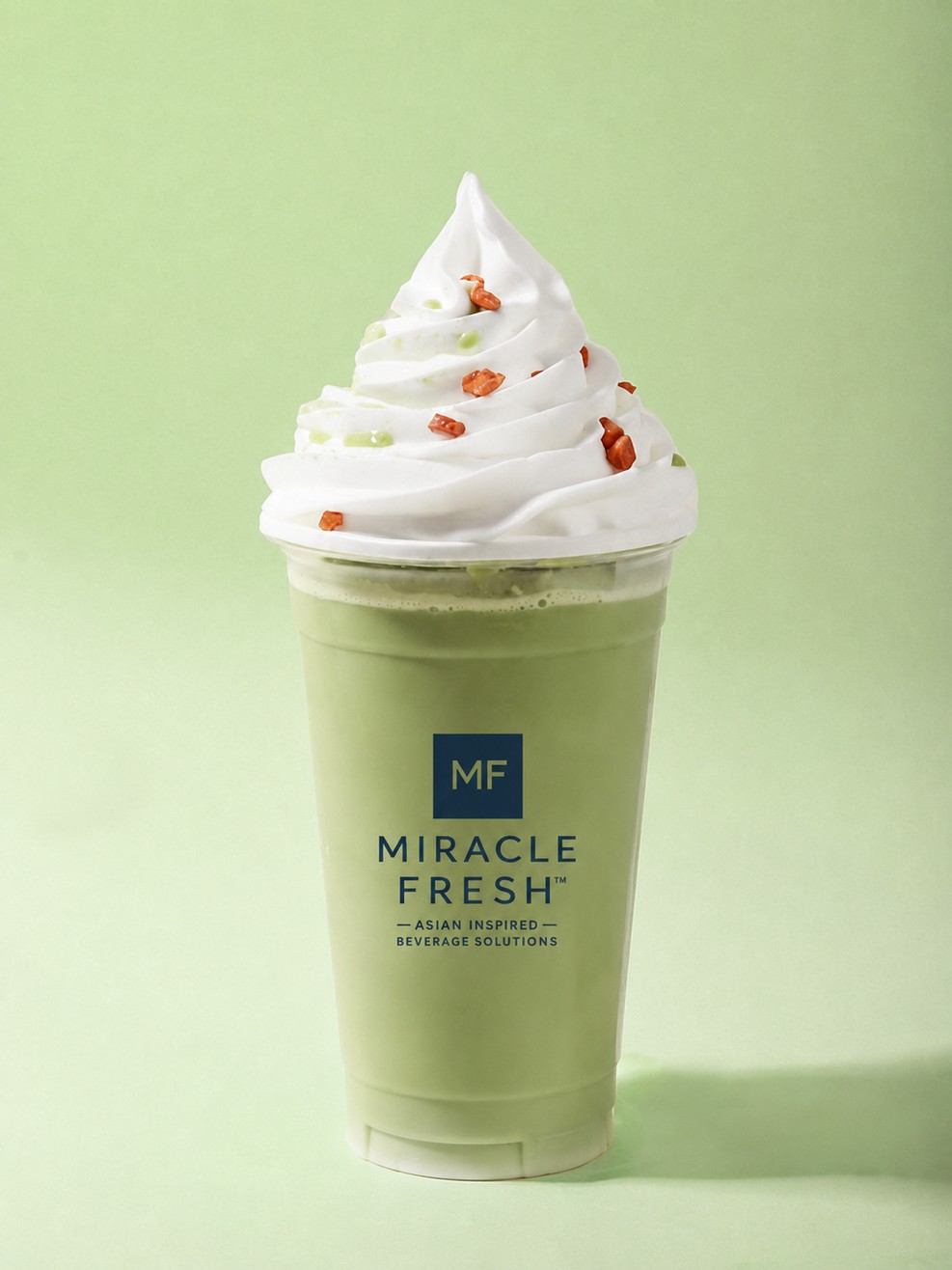 Matcha coconut swirl slush in a clear cup topped with soft-serve ice cream