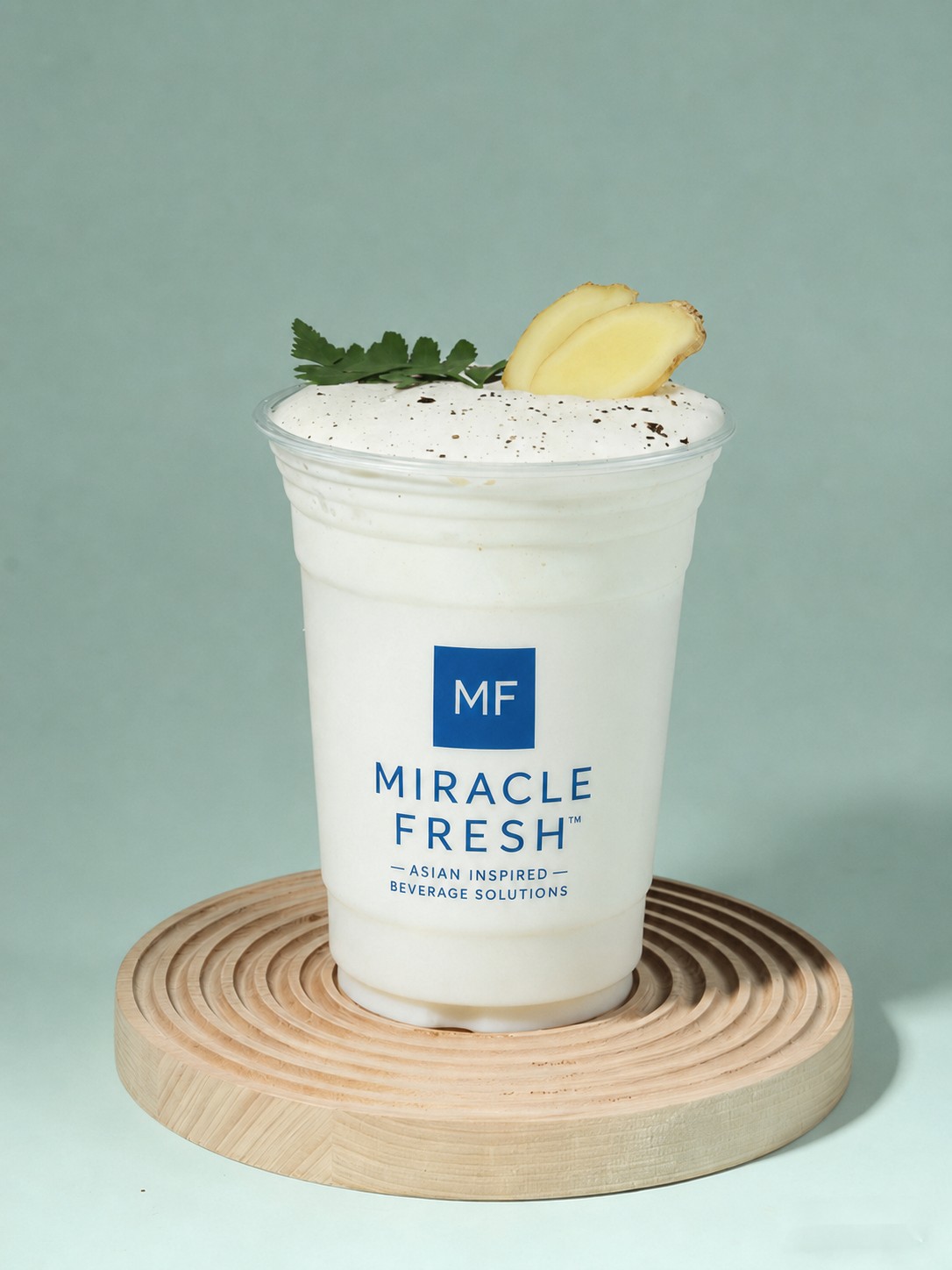 Creamy coconut slush topped with ginger milk-curd foam and ginger slices