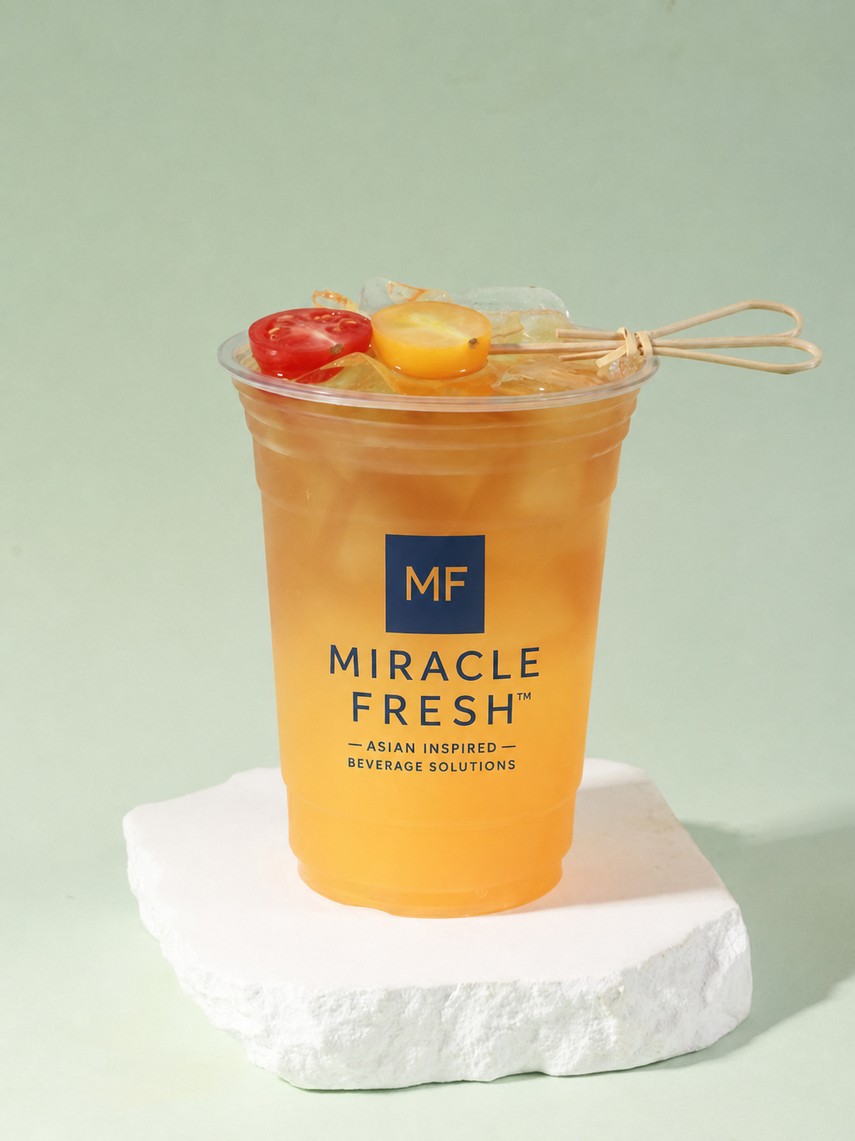 Sour papaya and tamarillo coconut water drink with a cold brew coffee top