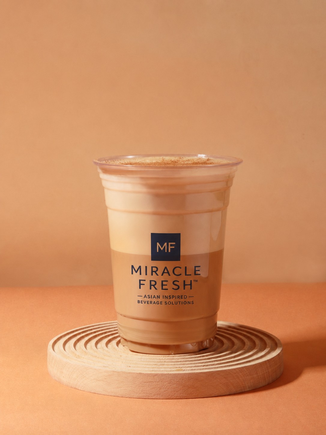 Black tea coffee topped with cake coconut foam in a Miracle Fresh cup