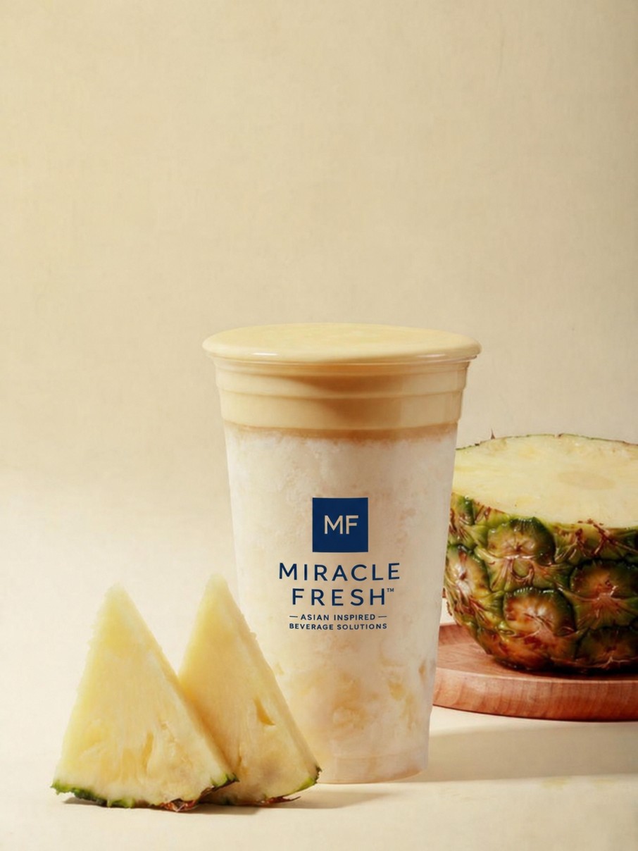 Pineapple coconut drink topped with roasted tea foam in a Miracle Fresh cup