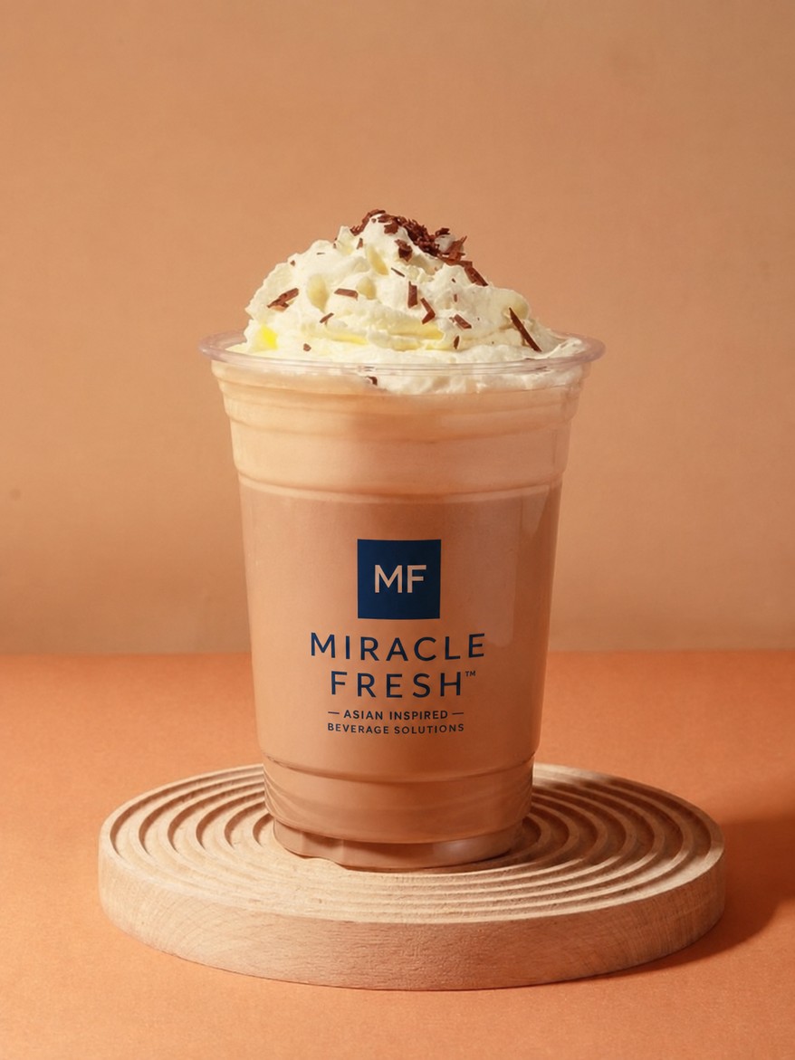 Iced green brick tea coffee topped with hazelnut foam in a Miracle Fresh cup